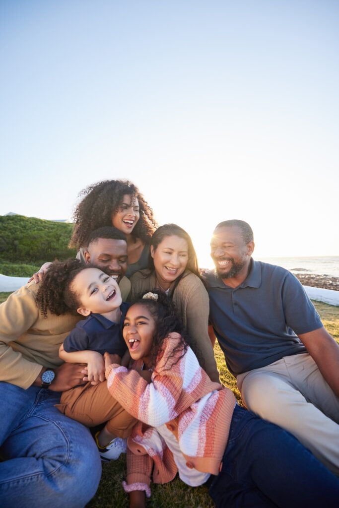 Family, laughing and outdoor with fun together with parents, kids and grandparents on holiday. Vaca