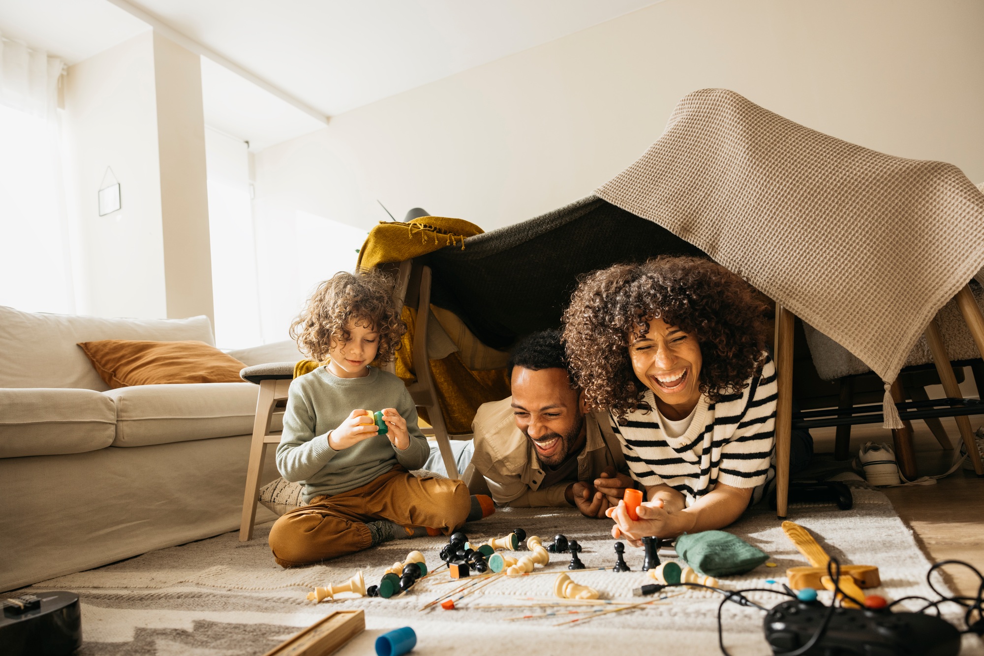Family laughing together in a living room.